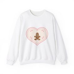 Stay cozy and festive with this gingerbread cookie Christmas crewneck sweatshirt. Perfect for those colder months, this medium-heavy fabric blend sweatshirt offers a comfy wearing experience with a clean-cut style. Ideal for anyone looking to add a touch of holiday cheer to their wardrobe. Product features - Knit in one piece without side seams for reduced fabric waste - Ribbed knit collar with seam for elasticity and shape retention - 50% cotton and 50% polyester fabric for a cozy feel - Classi Sweet Fall Crew Neck Top, Sweet Crew Neck Top For Fall, Sweet Winter Cotton Tops, Sweet Cotton Tops For Winter, Sweet Cotton Top For Winter, Xmas Gingerbread, Man Sweater, Cookie Christmas, Christmas Crewneck Sweatshirt