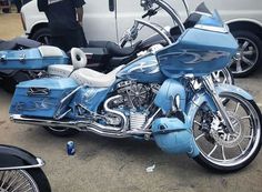 a blue motorcycle parked next to a white van