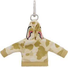 Keychain in silver tone. · Logo graphic camouflage pattern printed throughout · Lanyard clasp at top · Yellow graphic French terry charm at drop · Graphic embroidered at face and side · Logo flag at back face · H6 x W6 Supplier color: Yellow Shark Keychain, Fashion Pieces, Silver Accessories, Logo Graphic, Yellow Color, Tech Accessories, French Terry, Lanyard, Camouflage