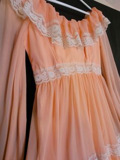 This beautiful peach dress is perfect for all your spring and summer events! Excellent condition! Bust-17" Waist-13" Length-4'8" Retro Peach Dress For Spring, Retro Spring Lace Dress, Retro Lace Dresses For Spring, Vintage Lace Dress With Ruffles For Spring, Vintage Spring Lace Dress With Ruffles, Vintage Orange Dress For Garden Party, Flowy Peach Dress For Wedding, Vintage Peach Evening Dress, Fitted Vintage Peach Dress