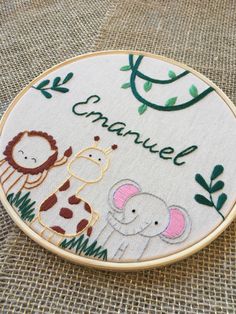 an embroidered name plate with animals on it and the words chandel written in cursive writing