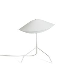 a white table lamp sitting on top of a metal stand