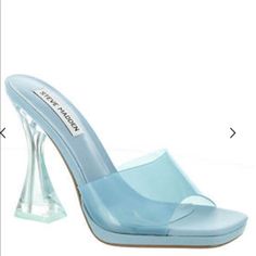 Clear Lucite Synthetic Banded Upper Open Square Toe Slip-On Styling Synthetic Lining Lightly Cushioned Footbed Man-Made-Outsole 4" Sculptural Heel Light Blue Synthetic Sandals For Evening, Light Blue Synthetic Heels For Evening, Blue Open Toe Sandals With Reinforced Heel, Modern Blue Sandals With Padded Heel, Blue Sandals With Reinforced Heel, Blue Synthetic Sandals With Sculpted Heel, Modern Blue Heels For Summer, Light Blue Closed Toe Heels In Synthetic, Clear Steve Madden Heels