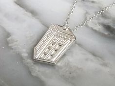 This sterling silver necklace is based on a traditional British Police Box - made famous by the TV show Doctor Who. Show off your time-travelling nerd pride, and be the most elegant geek in the room! The pendant is 2cm x 1.6cm and is hand-made from solid sterling silver. Made-to-order by our partner The Silver Sculptor, all jewelry comes in a gift box with ribbon, so it's ready for gift giving to friends or family - or a little treat just for you! Fandom Style Personalized Jewelry Gift, Personalized Fandom Jewelry Gift, Doctor Who Earrings, Doctor Who Jewelry, Star Wars Locket, British Police, Police Box, Geek Chic, Beautiful Vase