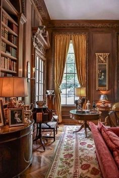 a living room filled with lots of furniture and bookshelves next to a window