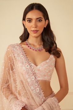 Blush pink net lehenga with thread and parsi embroidery. Comes with a padded blouse having cutdana embroidery and a net dupatta.
Component: 3
Pattern: Embroidered
Type Of Work: Thread, Parsi, Cutdana
Neckline: V Neck
Sleeve Type: Sleeveless
Fabric: Georgette, Dupatta : Net
Color: Pink
Other Details: 
Attached cancan
Note : Necklace worn by the model is not for sale.
Occasion: Wedding, Bride - Aza Fashions Pink Net Lehenga, Sawan Gandhi, Parsi Embroidery, Cutdana Embroidery, Pink Thread, Georgette Dupatta, Padded Blouse, Net Lehenga, Net Dupatta