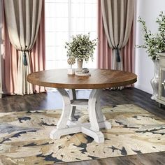 a living room scene with focus on the round table and floral arrangement in the center