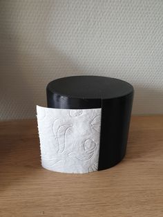 two rolls of toilet paper sitting on top of a wooden table