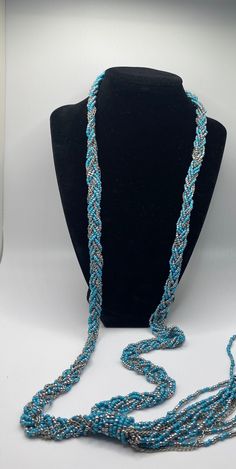 This is a beautiful necklace of 14 strands beads and chain, twisted together with wrapped "knot", Necklace is 18 inches, strands below knot are 7.5 inches.  The main colors are turquoise and silver. Beaded Blue Turquoise Lariat Necklace, Blue Beaded Lariat Turquoise Necklace, Blue Beaded Turquoise Lariat Necklace, Turquoise Lariat Beaded Necklaces, Turquoise Lariat Beaded Necklace, Necklace Turquoise, Southwestern Style, Knot Necklace, Beautiful Necklace