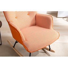 an orange and white checkered rocking chair