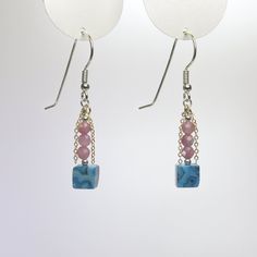 "These gemstone dangle earrings are handmade using blue crazy lace agate cubes and faceted pink tourmaline beads. Part of my \"Touch of Gold\" series, they are accented with segments of gold filled flat chain which flicker in the light. They're sure to attract attention. The sterling silver ear wires are also carefully handmade. Length: 1.75\" (44 mm) from top of ear wire. See image with ruler. Width: 0.25\" (6 mm) Dimensions are approximate. Crazy Lace Agate is named for its swirling and circul Rectangular Jewelry With Dangling Beads For Gifts, Gift Jewelry With Dangling Rectangular Beads, Handmade Square Pink Jewelry, Handmade Pink Square Jewelry, Northern Mexico, Circular Pattern, Tourmaline Beads, Touch Of Gold, Crazy Lace Agate