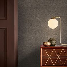 a table lamp sitting on top of a wooden dresser