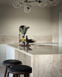 two stools sit at the bar in this modern kitchen