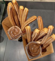 several churros with dipping sauce in small bowls