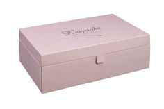 a pink box with the words keepsake on it's lid is shown in front of a white background