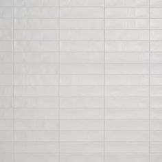 a white tiled wall and floor in a room