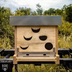 a wooden bird house with holes in it