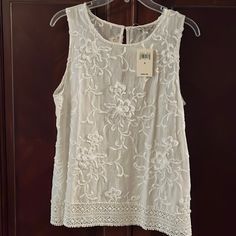 Embroidered With Flowers And Lace Along The Bottom. 100% Cotton. Nwt. Sleeveless Spring Embroidered Top With Floral Embroidery, Sleeveless Embroidered Top With Floral Design For Spring, Sleeveless Embroidered Floral Top For Spring, White Sleeveless Embroidered Top For Summer, Spring White Tank Top With Floral Embroidery, White Floral Embroidery Tank Top For Spring, Chic Sleeveless Embroidered Blouse, Sleeveless Floral Embroidered Blouse For Spring, Chic Embroidered Sleeveless Top For Summer