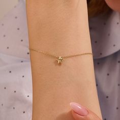 Elevate your wrist with our Minimalist Star Charm Chain Bracelet, a timeless piece of jewelry that exudes understated beauty. Crafted from high-quality 14k solid gold, this bracelet features a dainty and movable star-shaped charm, adding a touch of whimsy to the design. The minimalist chain enhances the elegance of the star charm, creating a captivating and versatile accessory. With multiple gold color options available, you can personalize this bracelet to match your individual style. The brace Dainty Star Charm Bracelet, Gold Star Charm Bracelet, Dainty Star-shaped Bracelets For Everyday Wear, Minimalist Bracelets With Star Charm, Gift Chain Bracelet With Star Charm, Dainty Bracelets With Star Charm For Gift, Dainty Star-shaped Bracelets For Gifts, Dainty Bracelets With Star Charm As Gift, Dainty Star-shaped Bracelet For Gift