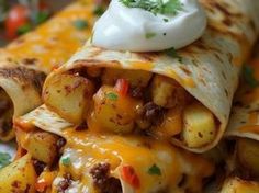 the burrito is loaded with potatoes, meat and sour cream on it's top