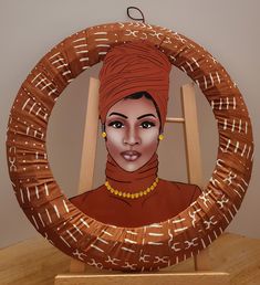 a painting of a woman in an orange turban on a wooden stand with a white wall behind it