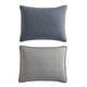 two gray and white pillows on top of each other, one has a black pillow