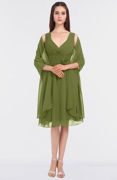 a woman is wearing a green dress