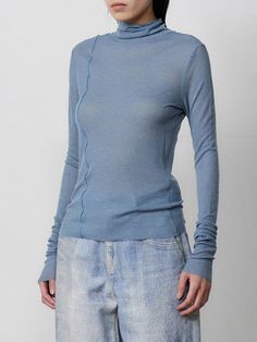 Editor's NotesThis slim-fit turtleneck T-shirt is cut from slight sheer variegated rib that's spun with eco-friendly Tencel and washable wool-blend. It features asymmetric stitched seamline at body and raw-edge finish that works well for the fabric character.- Turtleneck- Asymmetric stitch- Raw edge finish- Slim fitMeasurements (in.)One size- Shoulder: 13.8 in.- Chest: 15.6 in.- Sleeve Length: 27.2 in.- Total Length: 21.9 in.Model info: Height 5' 6.1, Weight 105.8 lbs, Bust 30, Waist 23Composition & Care- 70% Tencel, 30% Wool- Dry clean only- Do not hand wash- Do not tumble dry- Lay flat to dry in shade- Iron at low temperatureDesigner- by MMIC Blue Turtleneck For Spring, Blue Funnel Neck Tops For Spring, Blue Fine Knit Turtleneck Top, Fitted Fine Knit Turtleneck For Spring, Turtleneck T Shirt, Fitted Turtleneck, Raw Edge, Lay Flat, Wool Blend