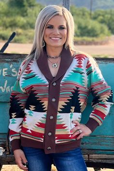 Transform your wardrobe with the Southern Roots Knit Sweater! Featuring a striking Aztec-inspired pattern in rich hues of brown, turquoise, cream, and red, this button up sweater is a must-have for the fashion-forward individual. Experience both warmth and style with this bold, eye-catching piece! No pockets 90% Polyester 10% Polyamide Size Fits XS 0 Small 2/4 Medium 6/8 Large 10/12 XL 14/16 2X 18/20 3X 22/24 Nine Line Apparel, Classy Cowgirl, Duster Dress, Dress Purse, Western Graphic Tees, Button Up Sweater, Jumpsuit Shorts Rompers, Stay Cozy, Womens Bodysuit