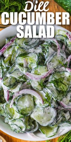 a white bowl filled with cucumber salad on top of a wooden table