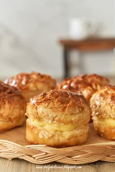 small pastries are sitting on a wicker platter, ready to be eaten