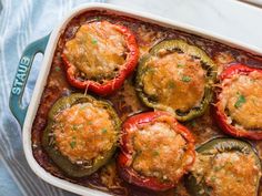 a casserole dish with stuffed peppers and cheese