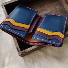 "This vertical leather wallet is designed for your joy and convenience. Joyful colors will give a good mood even on the most cloudy day. It is quite compact but roomy. You can always take six cards with you, the required number of banknotes, and there will still be two secret compartments for cards, checks, or banknotes. The Bifold Middle Wallet is made exclusively by my hands. I don't use a sewing machine and a press. Every detail is cut, sanded and sewn by my hands. You can be sure that you ar Joyful Colors, Origami Wallet, Trucker Wallet, Leather Wallet Design, Cash Holder, Biker Wallet, Handmade Wallets, Secret Compartment, Handmade Leather Wallet