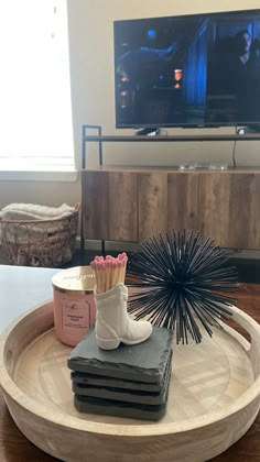 a living room with a television and some items on the table in front of it