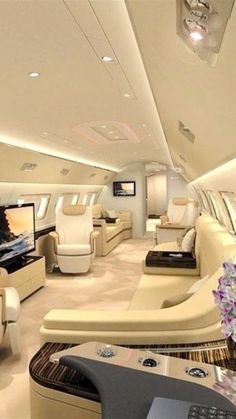 the interior of an airplane with couches and televisions