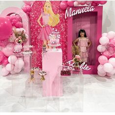 there is a barbie doll standing in front of a pink backdrop with balloons and decorations