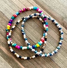 This personalized seed bead stretch cord bracelet comes in many different colors.  They are so cute!  Simply message me with the color or colors that you would like.  I have many other colors for you to create a custom bracelet as well.  This listing highlights most of them.  I am able to make the bracelets in size 6 1/2, 7, and 7 1/2.  This would be a great bracelet to stack with other bracelets.  They would also make a great gift!  There are lovely hoop earrings in my shop too that would look great with the bracelest!  Please remember to message me with the colors you would like.   ~I use high quality hypoallergenic materials along with many different colors and types of beads.  I work hard to create beautiful pieces and to provide excellent customer service.   Packaging All of my bracel Adjustable Bohemian Stretch Bracelet With Wooden Beads, Multicolor Tiny Beads Wrap Bracelet For Friendship, Multicolor Round Beads Wrap Bracelet For Friendship, Casual Beach Wrap Bracelet With Round Beads, Adjustable Wrap Bracelet With Colorful Heishi Beads, Adjustable Heishi Beads Wrap Bracelet With Colorful Beads, Casual Beach Stretch Bracelet With Wooden Beads, Colorful Adjustable Hand-strung Beaded Bracelets, Adjustable Colorful Hand-strung Stretch Bracelet