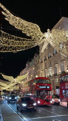 double decker bus driving down the street with christmas lights strung all over it's sides