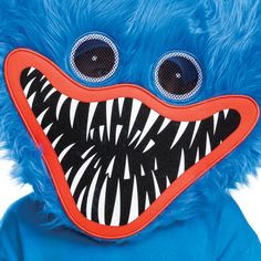 a blue stuffed animal with big eyes and teeth