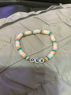 Outer banks bracelet with colors white, pink, orange, and blue. Could  fit adults with the elastic string I use. Outer Banks Bracelets Colors, Casual Multicolor Bracelets With Letter Beads, Casual Multicolor Letter Beads Bracelets, White Letter Beads Stretch Bracelet For Summer, White Stretch Bracelet With Letter Beads For Summer, Casual Orange Stretch Bracelet With Letter Beads, Casual Multicolor Wristband With Letter Beads, White Wristband With Colorful Beads For Friendship, White Colorful Beads Wristband For Beach