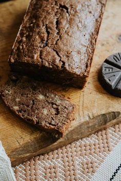 a loaf of brownies sitting on top of a wooden cutting board next to a knife