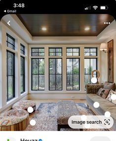 a living room filled with furniture and lots of windows