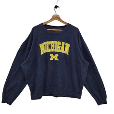 Crew Neck Top With Embroidered Logo For College, Oversized Collegiate Crew Sweater, Casual Tops With Embroidered Logo For Fan Gear, Oversized Collegiate Winter Tops, Winter College Tops With Embroidered Logo, Winter Fan Apparel Tops With Embroidered Logo, Casual Sweatshirt With Embroidered Graphics For Fans, Collegiate Embroidered Tops For College, Fall Campus Tops With Embroidered Graphics