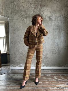 Archive 80s ISSEY MIYAKE SPORT multi-color wool check tweed suit, the tweed is a heavier weight with warm multi-color yarns (brown shades), lovely tailoring, the suit fits XS-M, gender neutral, no defects, and excellent condition. Trousers: fully lined, high-waisted with zip and tab closure, pockets front and back, pleated with a straight leg that tapers just slightly. Jacket: is a little oversized and cropped with shoulder pads, pockets, and double-breasted; elastic is hidden in the center back of the blazer and on sleeves, which creates a gathered look. Measurements: JACKET (fully lined, measurements taken flat) shoulder seam to seam 47 cm / 18.5"  underarm to underarm 53 cm / 21"  total length shoulder to hem 46 cm / 18"  sleeve 56 cm / 22"  TROUSERS (fully lined, measurements taken fla Retro Notch Lapel Suits For Fall, Retro Tailored Suit For Fall, Fall Retro Suits With Notch Lapel, Retro Fall Suits For Tailoring, Brown Wool Suits For Fall, Retro Notch Lapel Fall Suits, Retro Brown Tweed Jacket For Business, Vintage Brown Suit For Fall, Retro Plaid Tweed Jacket For Fall