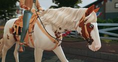 a person riding on the back of a brown and white horse