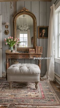 a room with a bench, mirror and flowers on the table in front of it