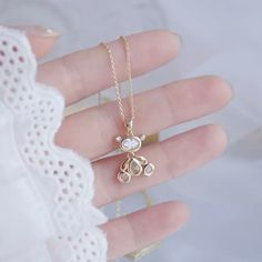 This beautiful 100% Chrystal Teddy Bear is designed to brighten your life and add some much needed sparkle to your closet. Shine bright like a diamond and accessorize like a pro. This beautiful necklace sits beautifully on any neckline, wear as a clavicle necklace or center on your breastbone. This Teddy Bear goes perfectly with any outfit or style and moves when you move - with ease. Made with extreme attention to every detail and facet, this beautiful flawless-cut teddy bear will bring complet Diamond White Cubic Zirconia Crystal Necklace As Gift, Diamond White Crystal Necklace For Gift, Gift Rhinestone Crystal Necklace With Sparkling Stones, Gift Crystal Rhinestone Necklace With Sparkling Stones, Gift Rose Gold Rhinestone Necklace, Sparkling Crystal Rhinestone Necklace Gift, White Round Rhinestone Necklace For Gift, White Round Rhinestone Necklace Gift, Round White Rhinestone Necklace Gift