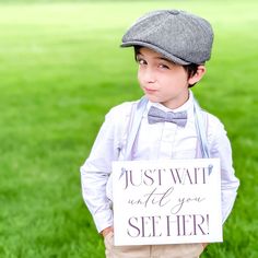 a young boy holding a sign that says i can't be first with the kings