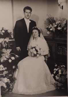 an old black and white photo of a bride and groom posing for a wedding photograph