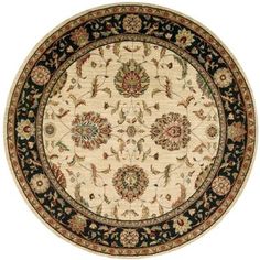 a round rug with an ornate design on the center and black border, in front of a white background